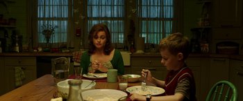 Movie still from “The Young and Prodigious T.S. Spivet” (2013), directed by Jean-Pierre Jeunet – A woman sitting at a dinner table with a child; Medium shot, Over the shoulder angle