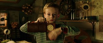 Movie still from “The Young and Prodigious T.S. Spivet” (2013), directed by Jean-Pierre Jeunet – A young boy holding an alarm clock in his hand; Close Up shot, Low angle