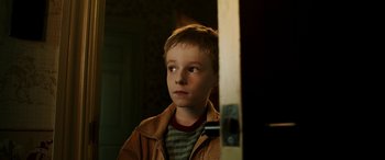 Movie still from “The Young and Prodigious T.S. Spivet” (2013), directed by Jean-Pierre Jeunet – A young boy is looking into a mirror; Close Up shot, Over the shoulder angle