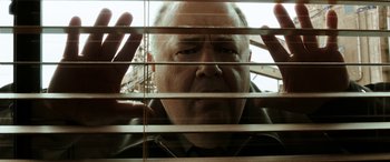 Movie still from “The Young and Prodigious T.S. Spivet” (2013), directed by Jean-Pierre Jeunet – A person looking through blinds; Close Up shot, Low angle