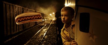 Movie still from “The Young and Prodigious T.S. Spivet” (2013), directed by Jean-Pierre Jeunet – A boy standing on the side of a train track next to train tracks; Close Up shot, Over the shoulder angle