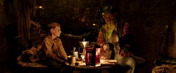 Movie still from “The Young and Prodigious T.S. Spivet” (2013), directed by Jean-Pierre Jeunet – A group of people sitting around a table; Medium shot, Over the shoulder angle