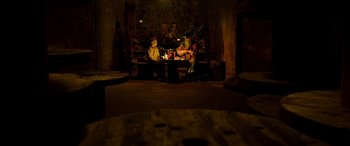 Movie still from “The Young and Prodigious T.S. Spivet” (2013), directed by Jean-Pierre Jeunet – Two people sitting on a couch in a dark room; Wide shot, High angle