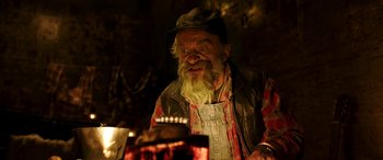 Movie still from “The Young and Prodigious T.S. Spivet” (2013), directed by Jean-Pierre Jeunet – An old man with a beard is sitting at a table; Close Up shot, High angle