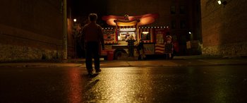Movie still from “The Young and Prodigious T.S. Spivet” (2013), directed by Jean-Pierre Jeunet – A man standing in front of a hotdog stand; Extreme Wide shot, High angle