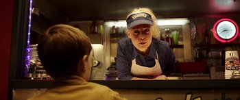 Movie still from “The Young and Prodigious T.S. Spivet” (2013), directed by Jean-Pierre Jeunet – A woman in an apron looking at a boy in a kitchen; Close Up shot, Over the shoulder angle