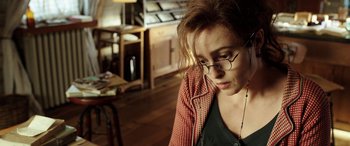 Movie still from “The Young and Prodigious T.S. Spivet” (2013), directed by Jean-Pierre Jeunet – A person wearing glasses and a jacket; Close Up shot, High angle