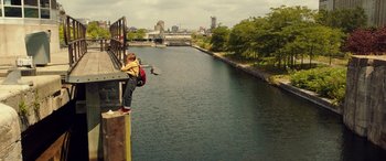 Movie still from “The Young and Prodigious T.S. Spivet” (2013), directed by Jean-Pierre Jeunet – A person standing on the side of a river; Extreme Wide shot, High angle