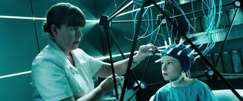 Movie still from “The Young and Prodigious T.S. Spivet” (2013), directed by Jean-Pierre Jeunet – A woman and a child are working on a project; Medium shot, Over the shoulder angle