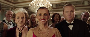 Movie still from “The Young and Prodigious T.S. Spivet” (2013), directed by Jean-Pierre Jeunet – A group of people standing in front of a chandelier; Close Up shot, Low angle