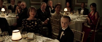 Movie still from “The Young and Prodigious T.S. Spivet” (2013), directed by Jean-Pierre Jeunet – A group of people sitting around a table; Medium shot, Over the shoulder angle