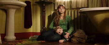Movie still from “The Young and Prodigious T.S. Spivet” (2013), directed by Jean-Pierre Jeunet – A woman sitting on the floor next to a child; Medium shot, High angle