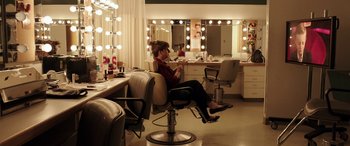 Movie still from “The Young and Prodigious T.S. Spivet” (2013), directed by Jean-Pierre Jeunet – A woman sitting in a chair in front of a mirror in a salon; Wide shot, Over the shoulder angle
