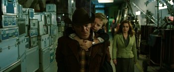 Movie still from “The Young and Prodigious T.S. Spivet” (2013), directed by Jean-Pierre Jeunet – A man in a cowboy hat is holding a young boy in his arms; Medium shot, Over the shoulder angle