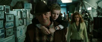 Movie still from “The Young and Prodigious T.S. Spivet” (2013), directed by Jean-Pierre Jeunet – A man and a boy are standing together; Medium shot, Over the shoulder angle