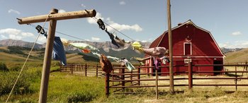 Movie still from “The Young and Prodigious T.S. Spivet” (2013), directed by Jean-Pierre Jeunet – Clothes are hanging on a clothes line in a fenced in area; Extreme Wide shot, Low angle