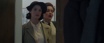 Movie still from “Their Finest” (2016), directed by Lone Scherfig – Two women are looking in the mirror; Medium shot, Over the shoulder angle