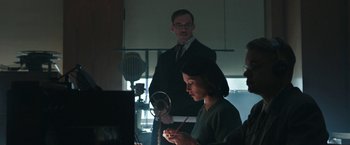 Movie still from “Their Finest” (2016), directed by Lone Scherfig – A man and a woman in front of a mirror; Medium shot, Low angle