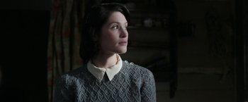Movie still from “Their Finest” (2016), directed by Lone Scherfig – A woman in a gray sweater looking to her left; Close Up shot, Over the shoulder angle