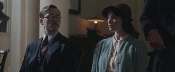 Movie still from “Their Finest” (2016), directed by Lone Scherfig – A man and a woman are sitting next to each other; Medium shot, Over the shoulder angle
