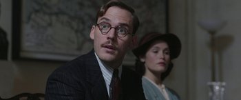 Movie still from “Their Finest” (2016), directed by Lone Scherfig – A man and a woman are sitting in a room; Close Up shot, Low angle