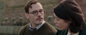 Movie still from “Their Finest” (2016), directed by Lone Scherfig – A man and a woman are looking at one another; Close Up shot, Over the shoulder angle