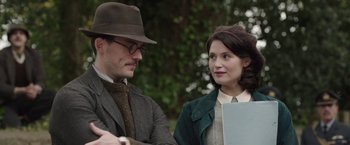 Movie still from “Their Finest” (2016), directed by Lone Scherfig – A man and a woman standing next to each other; Close Up shot, Over the shoulder angle