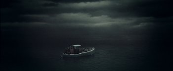 Movie still from “Their Finest” (2016), directed by Lone Scherfig – A boat with people on it in the middle of the night; Extreme Wide shot, High angle