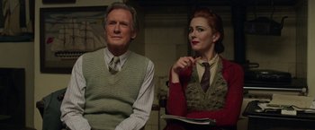 Movie still from “Their Finest” (2016), directed by Lone Scherfig – A man and a woman sitting next to each other; Medium shot, Low angle