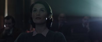 Movie still from “Their Finest” (2016), directed by Lone Scherfig – A woman in a dark room looking to her left; Close Up shot, Low angle