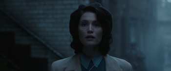 Movie still from “Their Finest” (2016), directed by Lone Scherfig – A woman in a blue shirt and a black jacket; Close Up shot, Over the shoulder angle