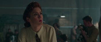 Movie still from “Their Finest” (2016), directed by Lone Scherfig – A woman smoking a cigarette while wearing a dress shirt; Close Up shot, Low angle