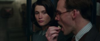 Movie still from “Their Finest” (2016), directed by Lone Scherfig – A man and a woman looking in the same direction in the same direction; Close Up shot, Over the shoulder angle