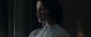 Movie still from “Their Finest” (2016), directed by Lone Scherfig – A woman with her eyes closed looking down; Close Up shot, Low angle