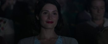 Movie still from “Their Finest” (2016), directed by Lone Scherfig – A person wearing a necklace; Close Up shot, Over the shoulder angle
