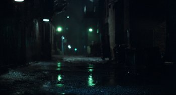 Movie still from “Thief” (1981), directed by Michael Mann – A dark street with a lot of green lights; Wide shot, Low angle