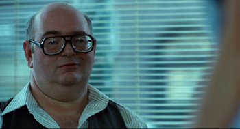 Movie still from “Thief” (1981), directed by Michael Mann – A man with glasses is looking at the camera; Close Up shot, Over the shoulder angle