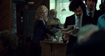 Movie still from “Thief” (1981), directed by Michael Mann – A woman in a blue dress and a man in a black suit; Medium shot, Over the shoulder angle