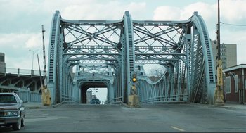 Movie still from “Thief” (1981), directed by Michael Mann – A man standing on the side of a road next to a traffic light; Extreme Wide shot, Low angle
