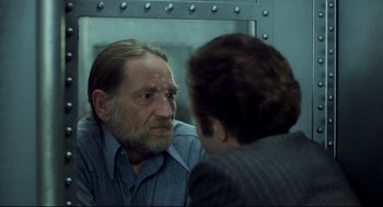 Movie still from “Thief” (1981), directed by Michael Mann – An older man looking at himself in the mirror; Close Up shot, Over the shoulder angle