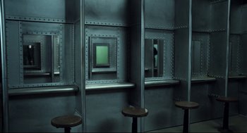 Movie still from “Thief” (1981), directed by Michael Mann – A room that has a mirror on the wall; Wide shot, High angle