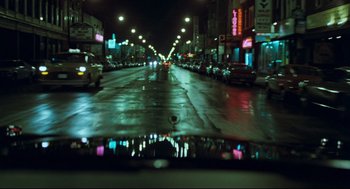 Movie still from “Thief” (1981), directed by Michael Mann – A view of a city street at night from a car window; Extreme Wide shot, High angle