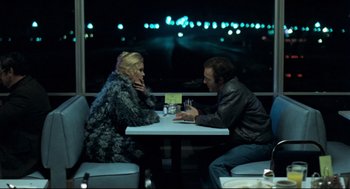 Movie still from “Thief” (1981), directed by Michael Mann – A man and a woman sitting at a dinner table; Medium shot, Over the shoulder angle