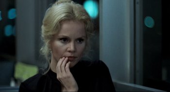 Movie still from “Thief” (1981), directed by Michael Mann – A woman in a black shirt is looking at the camera; Close Up shot, Over the shoulder angle