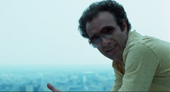 Movie still from “Thief” (1981), directed by Michael Mann – A person wearing glasses and a yellow shirt; Close Up shot, Low angle