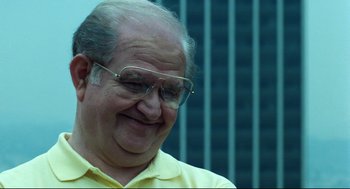 Movie still from “Thief” (1981), directed by Michael Mann – An older man wearing glasses and a yellow shirt; Close Up shot, Low angle