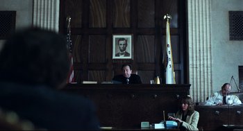 Movie still from “Thief” (1981), directed by Michael Mann – A judge sitting in front of a judge's bench; Medium shot, Low angle