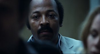 Movie still from “Thief” (1981), directed by Michael Mann – A person wearing a suit and tie; Close Up shot, Low angle