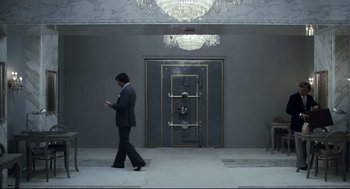 Movie still from “Thief” (1981), directed by Michael Mann – A man walking in front of an entrance to a building; Wide shot, Low angle