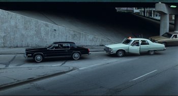 Movie still from “Thief” (1981), directed by Michael Mann – Two cars are stopped on the side of the road; Wide shot, High angle